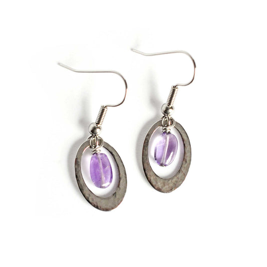 Oval drop earrings with hanging Amethyst oval stone on white background.