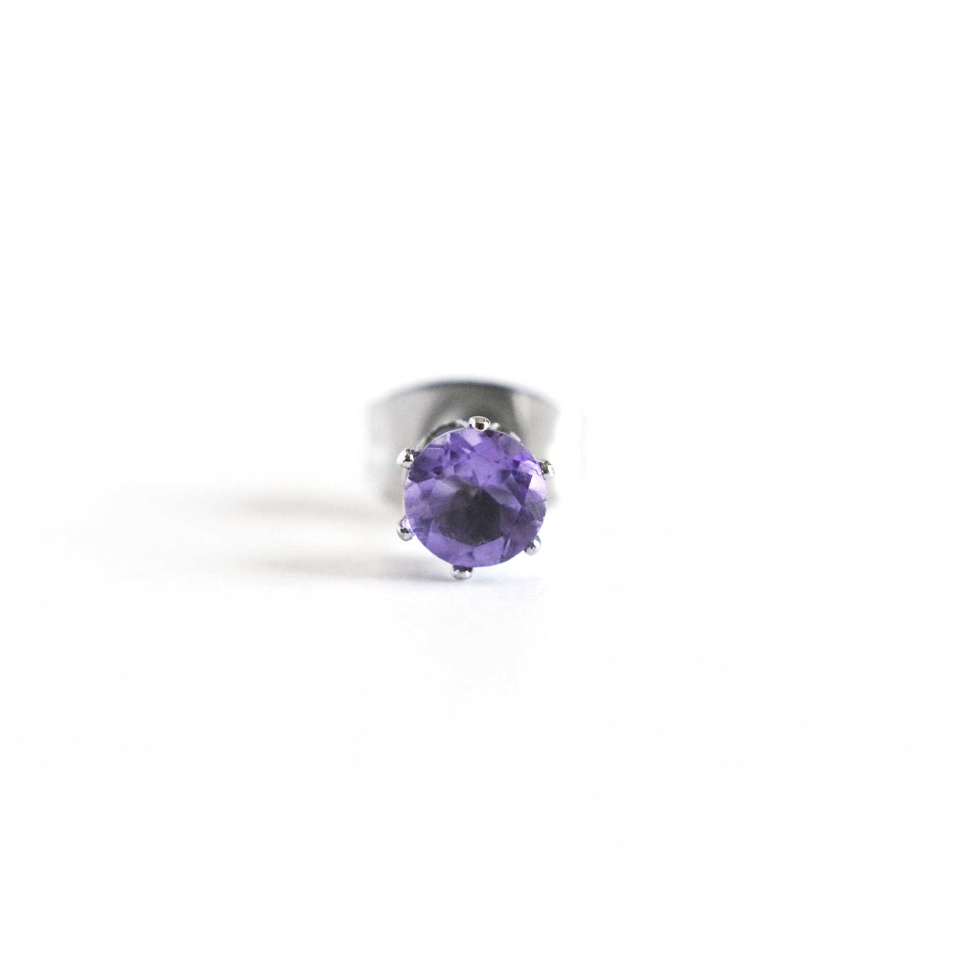 Front view of purple Amethyst faceted gemstone stud earring on white background