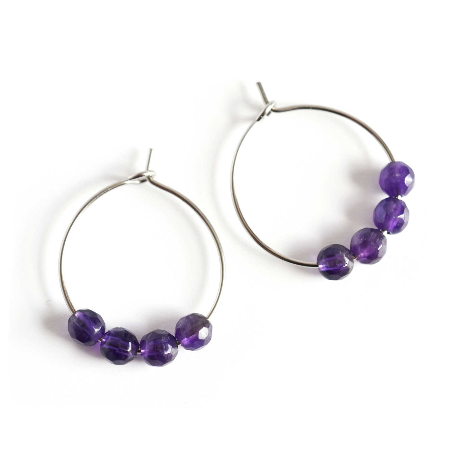 Pair of purple Amethyst hoop earrings with surgical steel hoops on white background