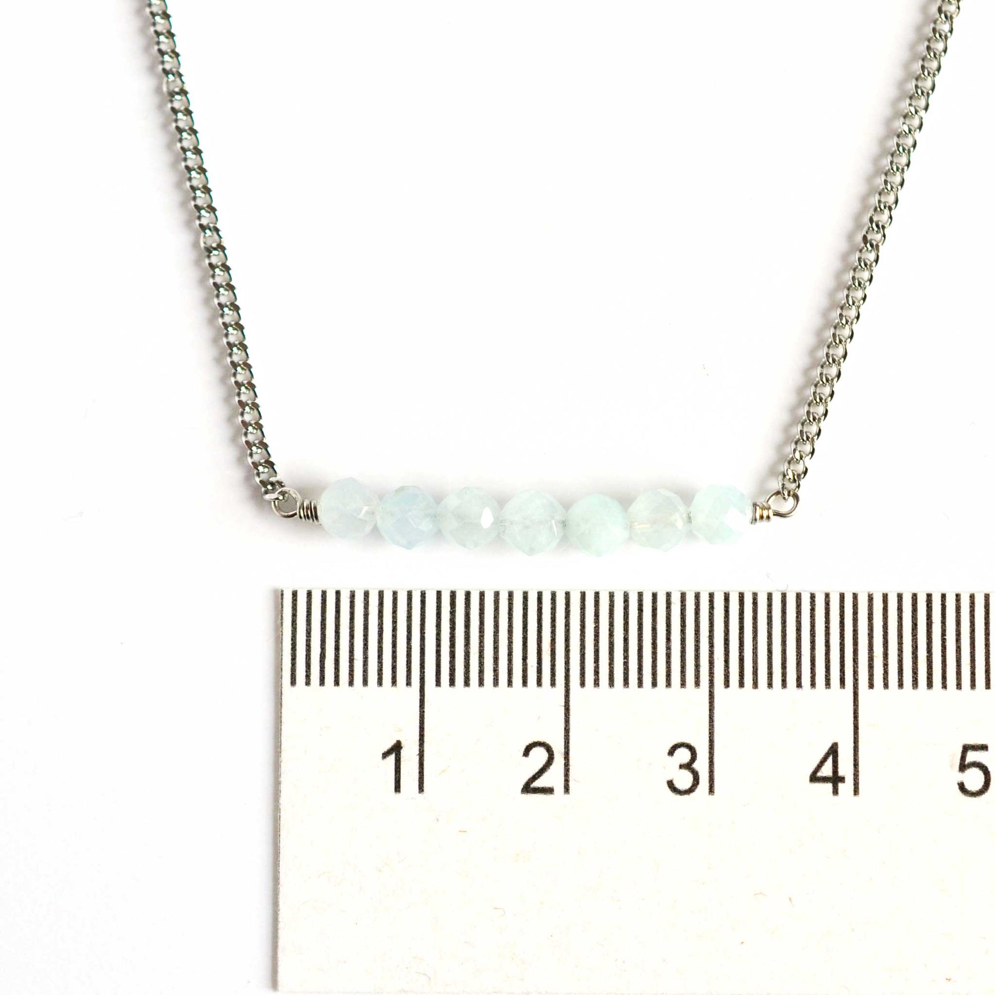 Dainty Aquamarine necklace with 4mm gemstone beads next to ruler