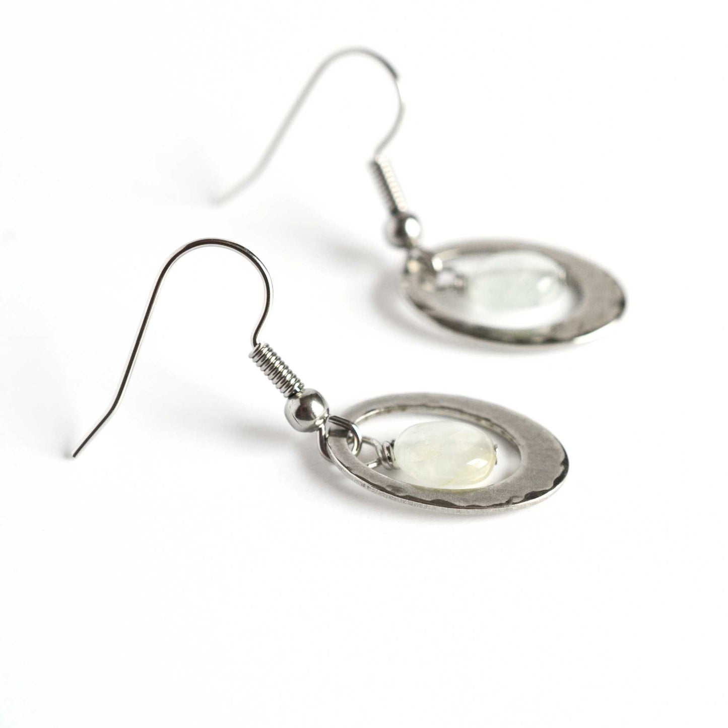 Side view detail of Aquamarine gemstone and stainless steel hammered oval drop earrings.