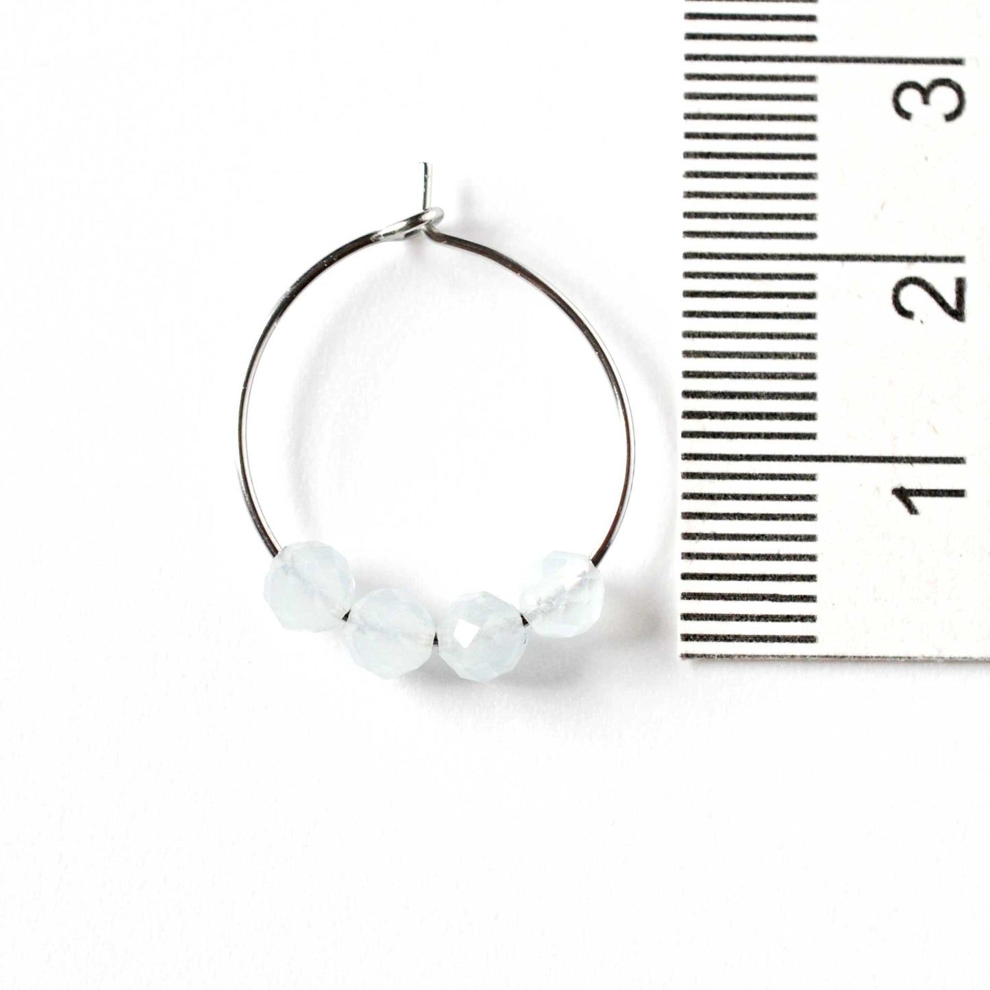 2cm diameter Aquamarine hoop earrings next to ruler