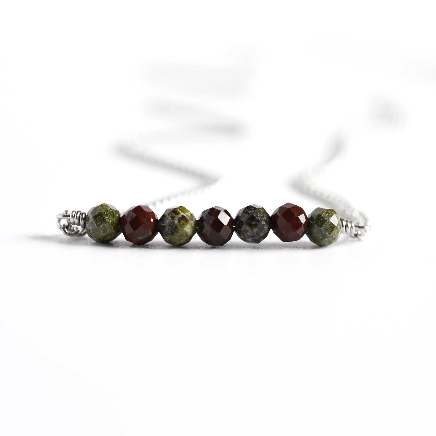 Close up of Bloodstone necklace with seven small round dark green faceted Bloodstone gemstones