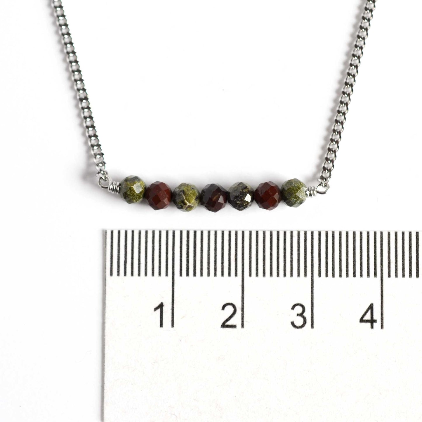 Dainty Bloodstone necklace with 4mm green stone beads next to ruler