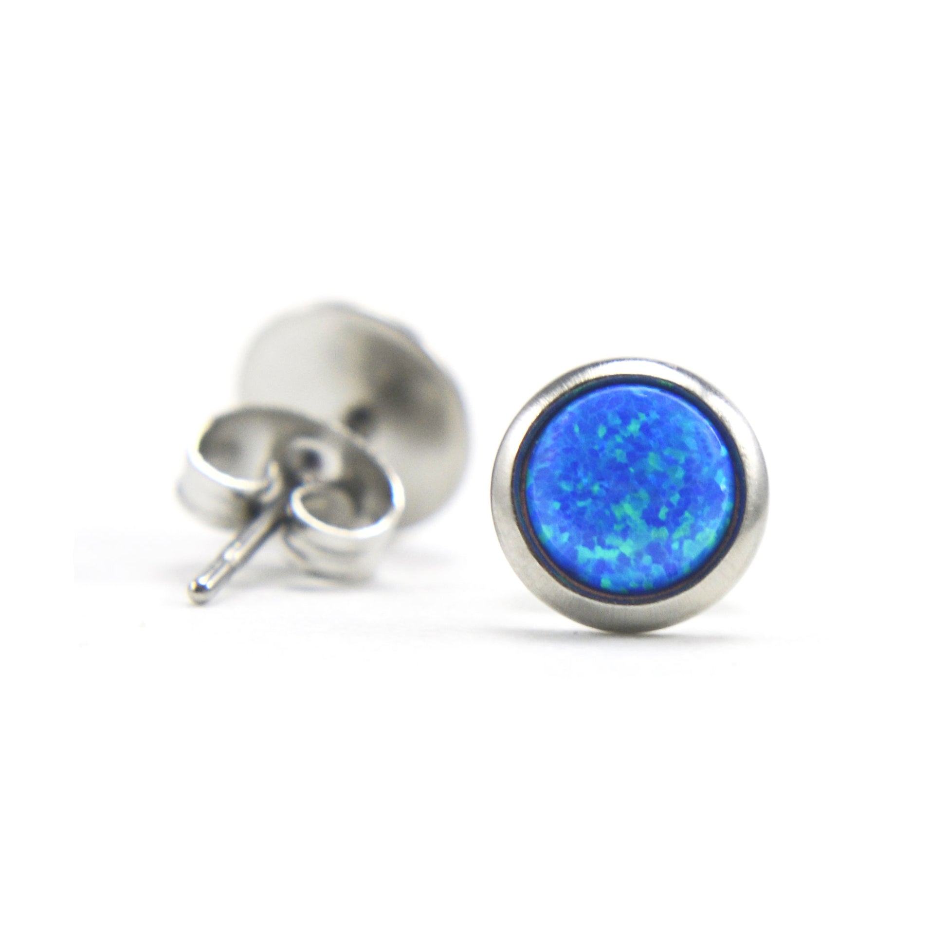 Close up of blue Opal and surgical steel stud earrings on white background