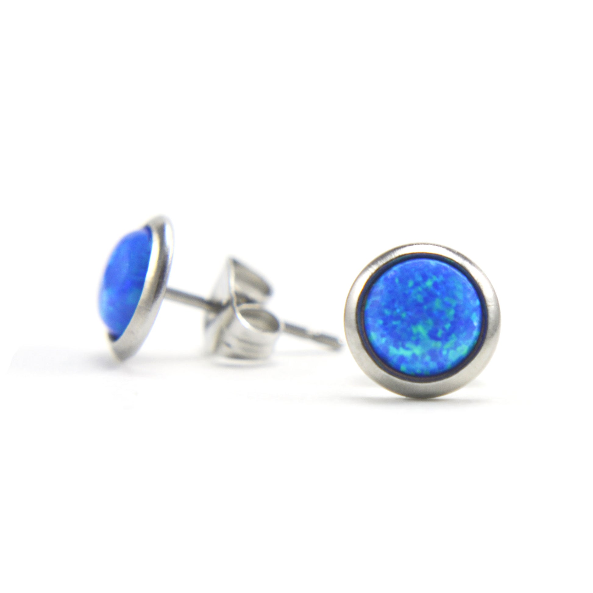 Round blue Opal stud earrings on white background