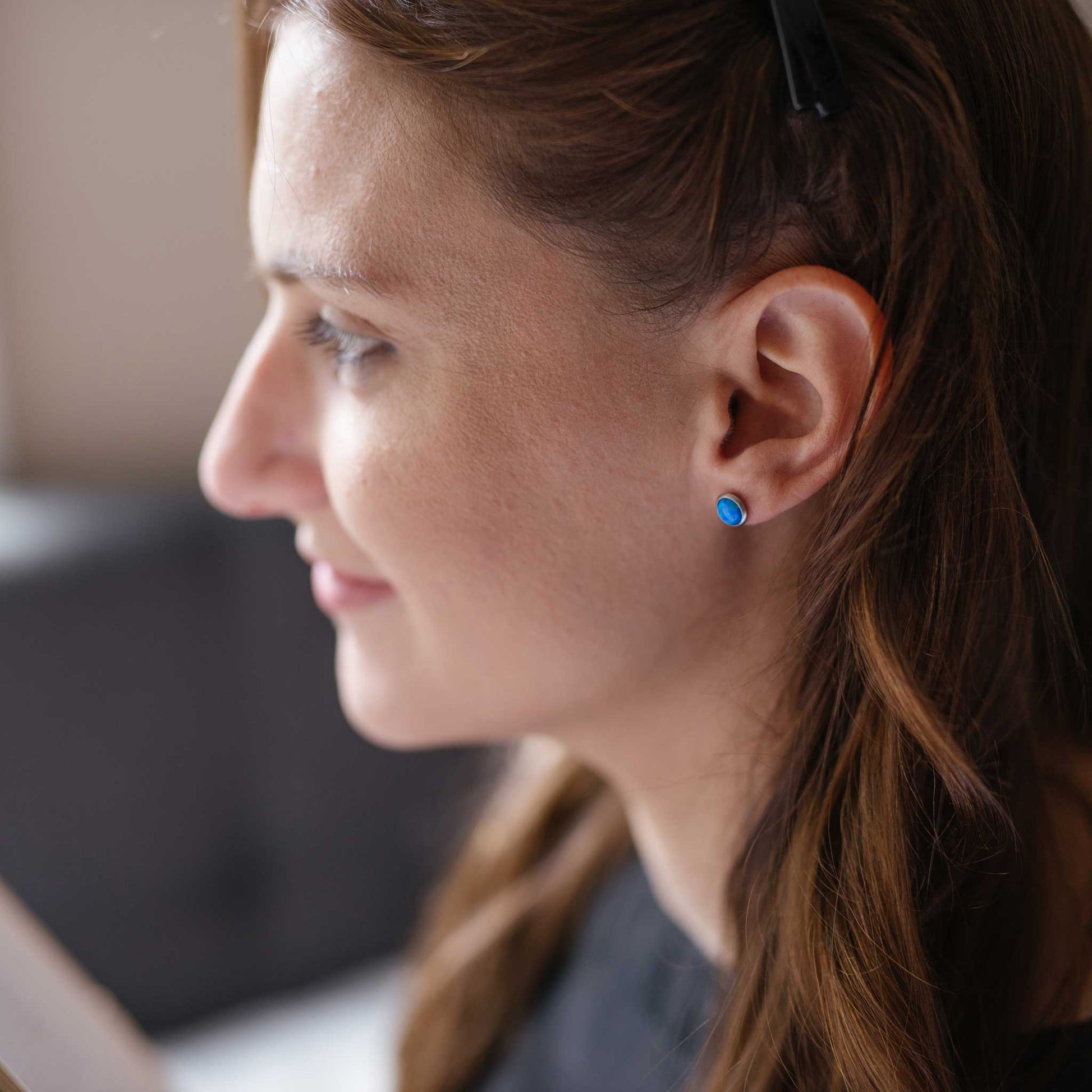 Woman wearing hypoallergenic blue Opal earrings