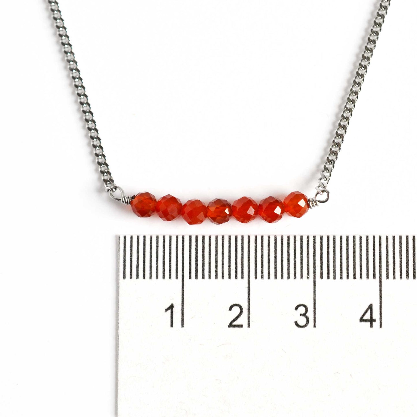 Dainty Carnelian necklace with orange stones 4mm next to ruler