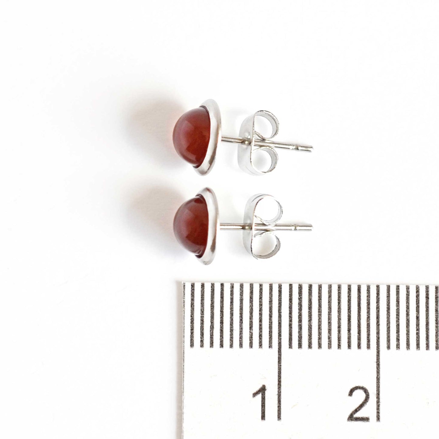 8mm wide Carnelian earrings next to ruler