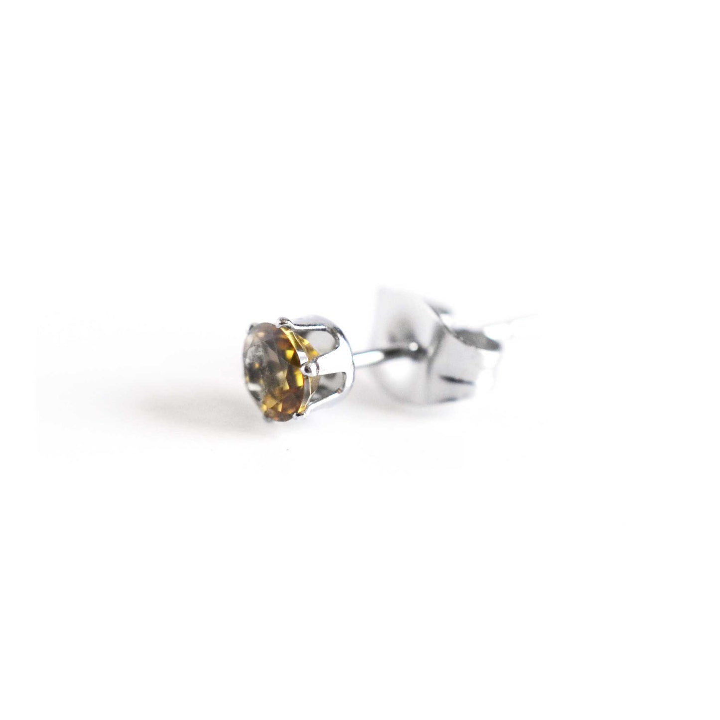 Side view of yellow Citrine faceted stud earring with butterfly back on white background