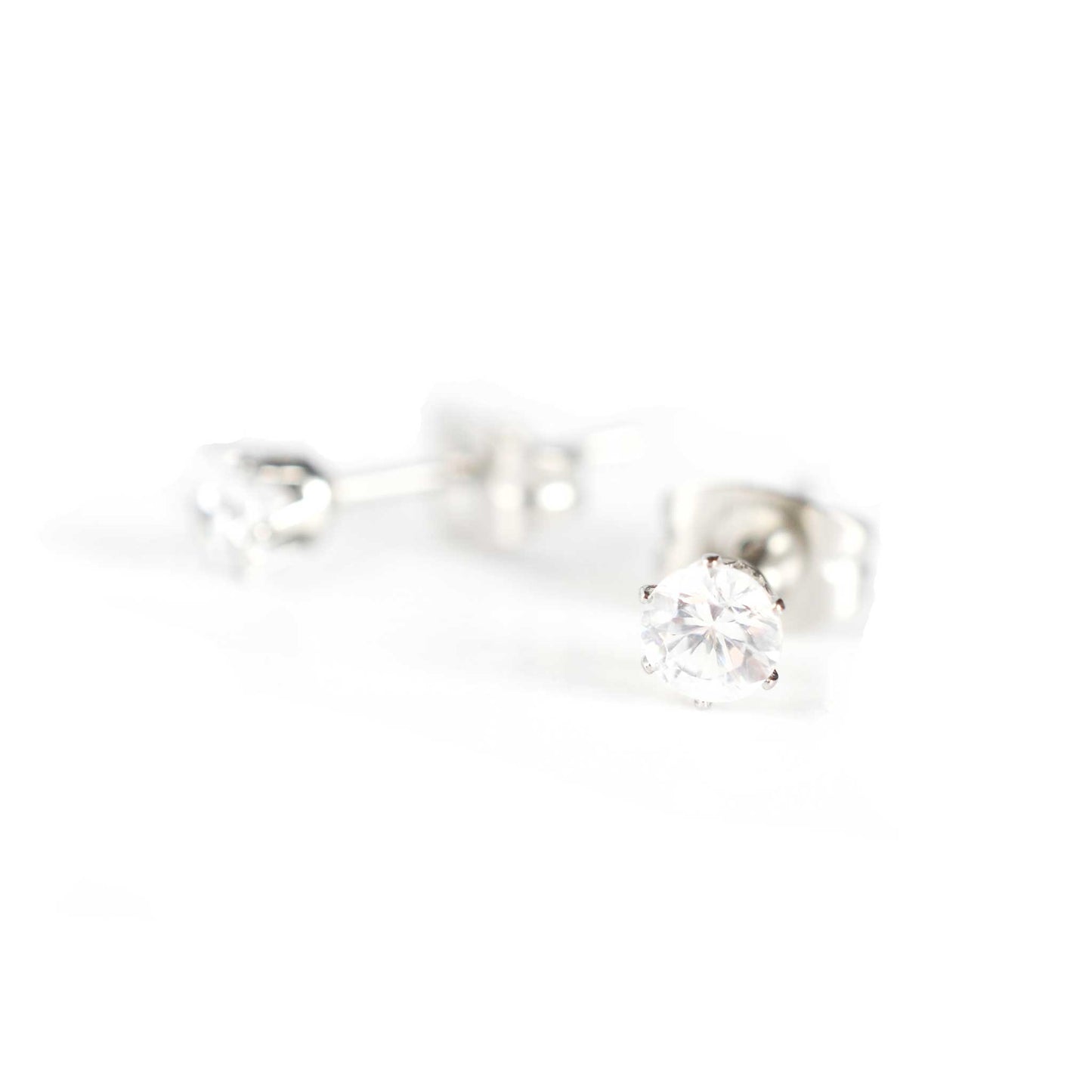 Tiny clear Cubic Zirconia gemstone stud earrings on white background