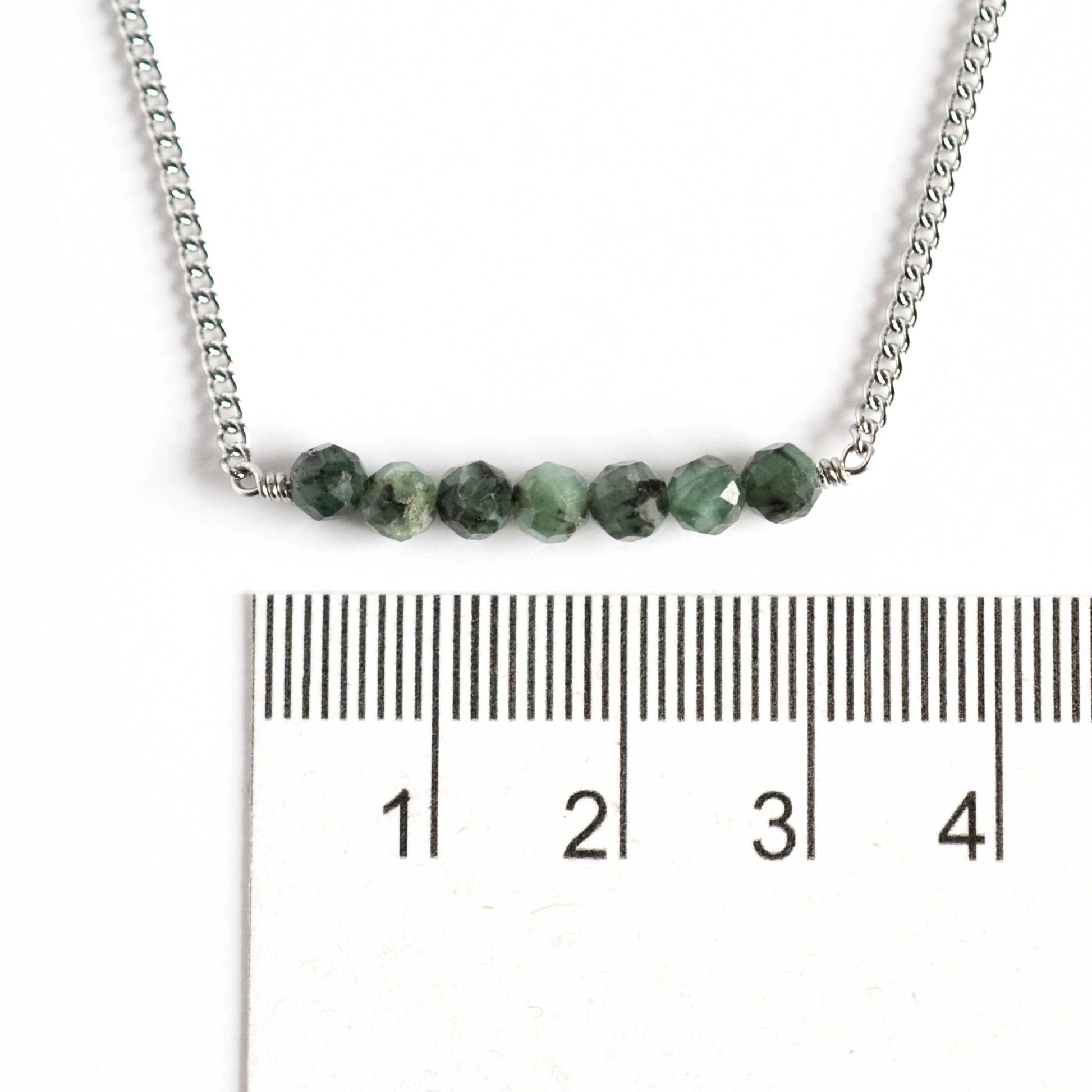 Dainty Emerald necklace with 4mm gemstones next to ruler