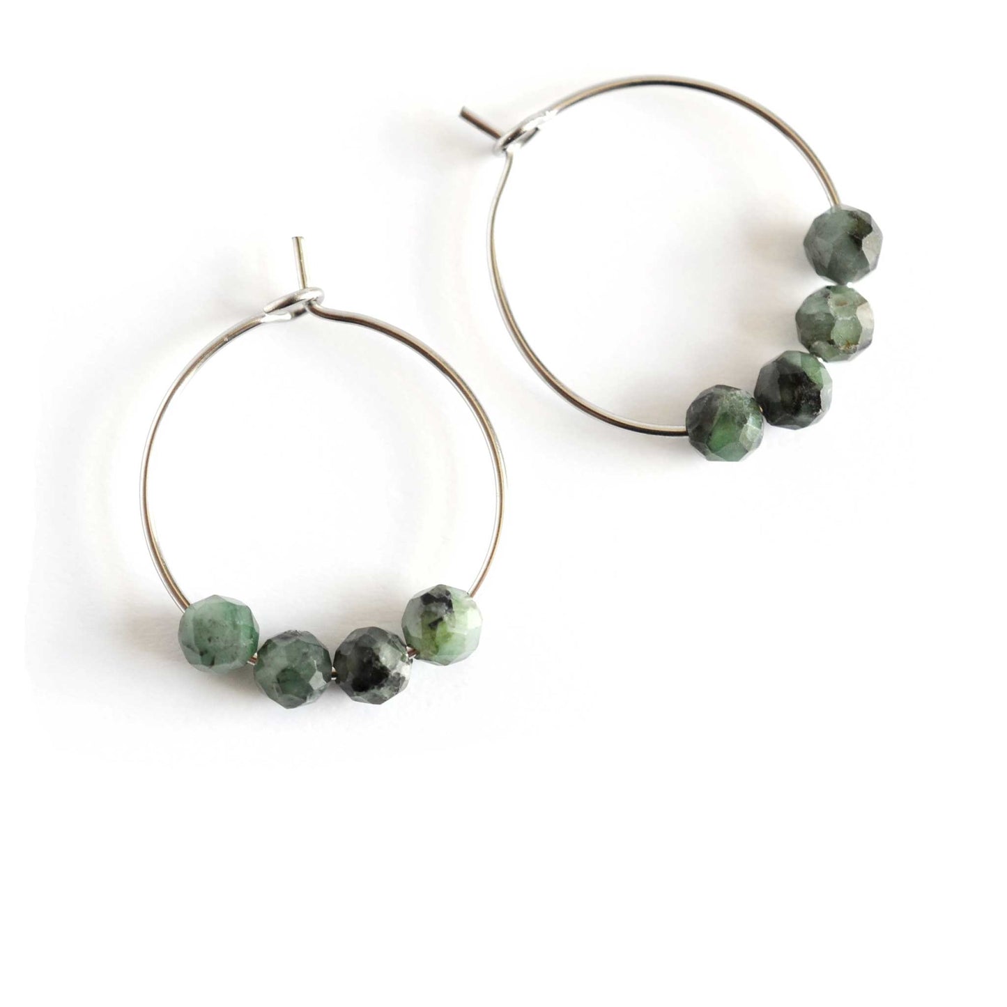 Park of dark green natural Emerald hoop earrings on white background
