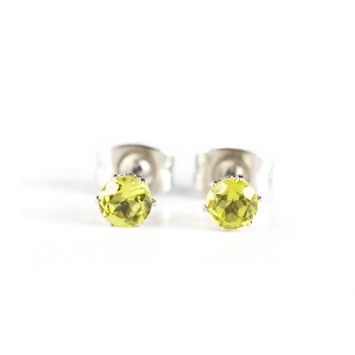 Front view of tiny faceted Peridot gemstone stud earrings on white background