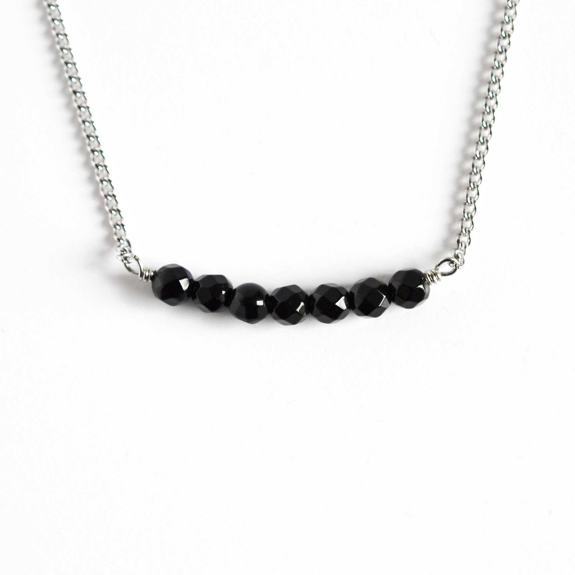 Onyx necklace black stone and stainless steel on white background
