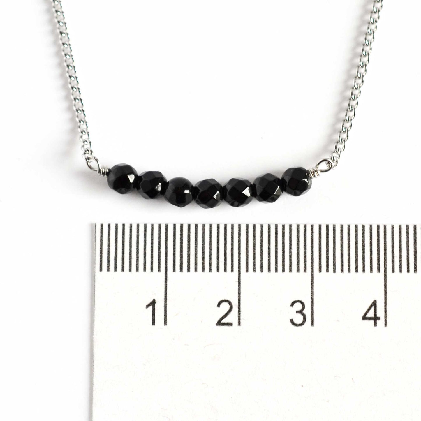 Dainty Onyx necklace with 4mm gemstone beads next to ruler