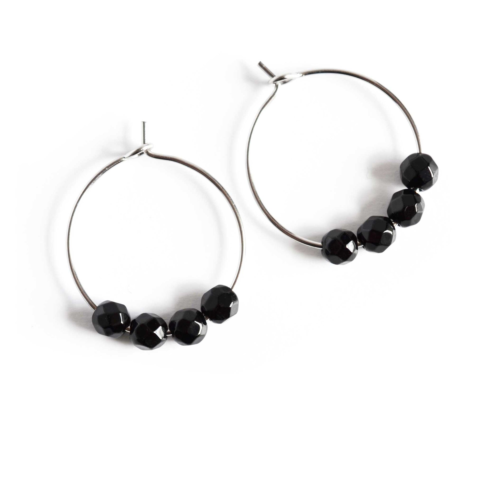 Pair of simple Onyx gemstone black hoop earrings on white background