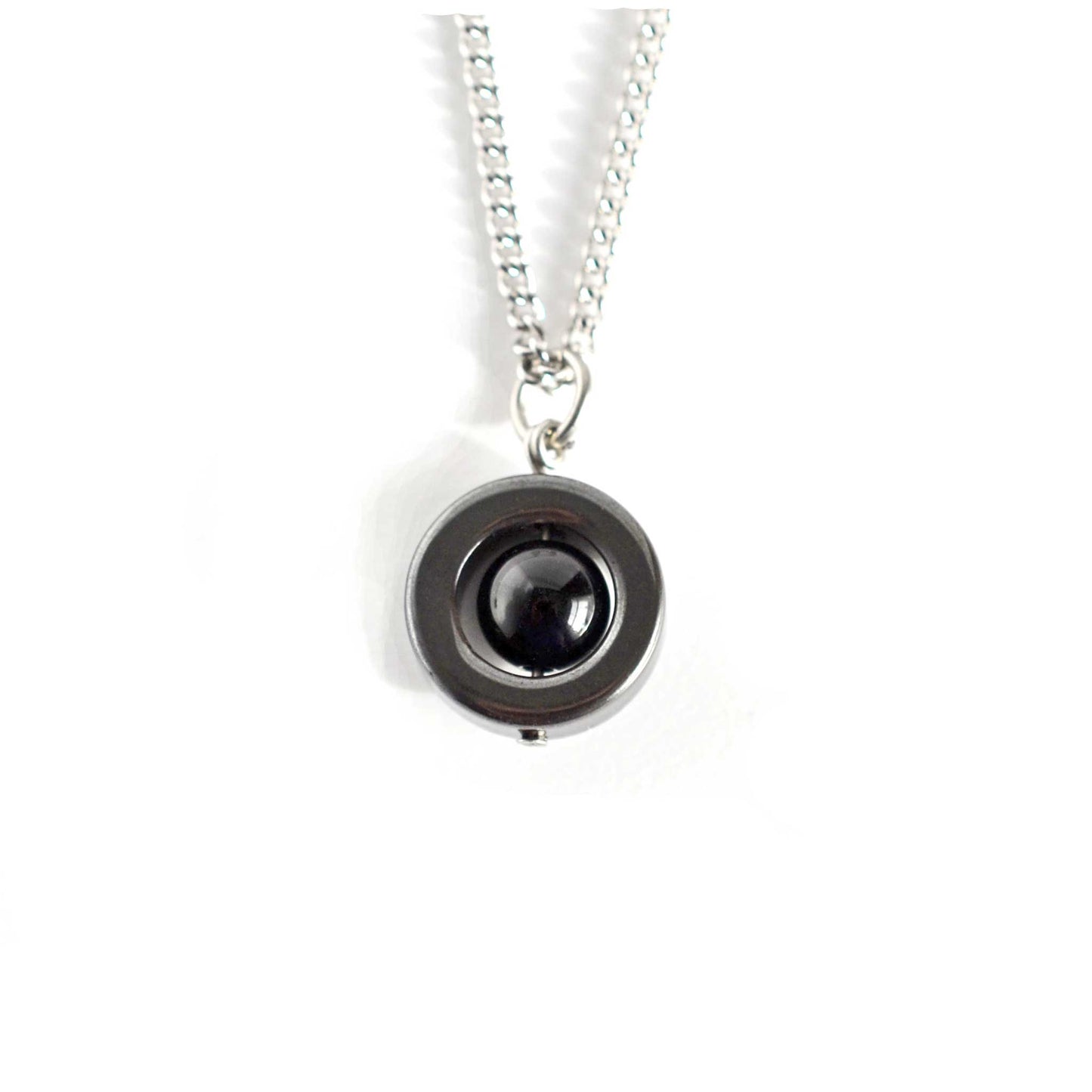 Hematite and black Onyx spinner necklace on white background.