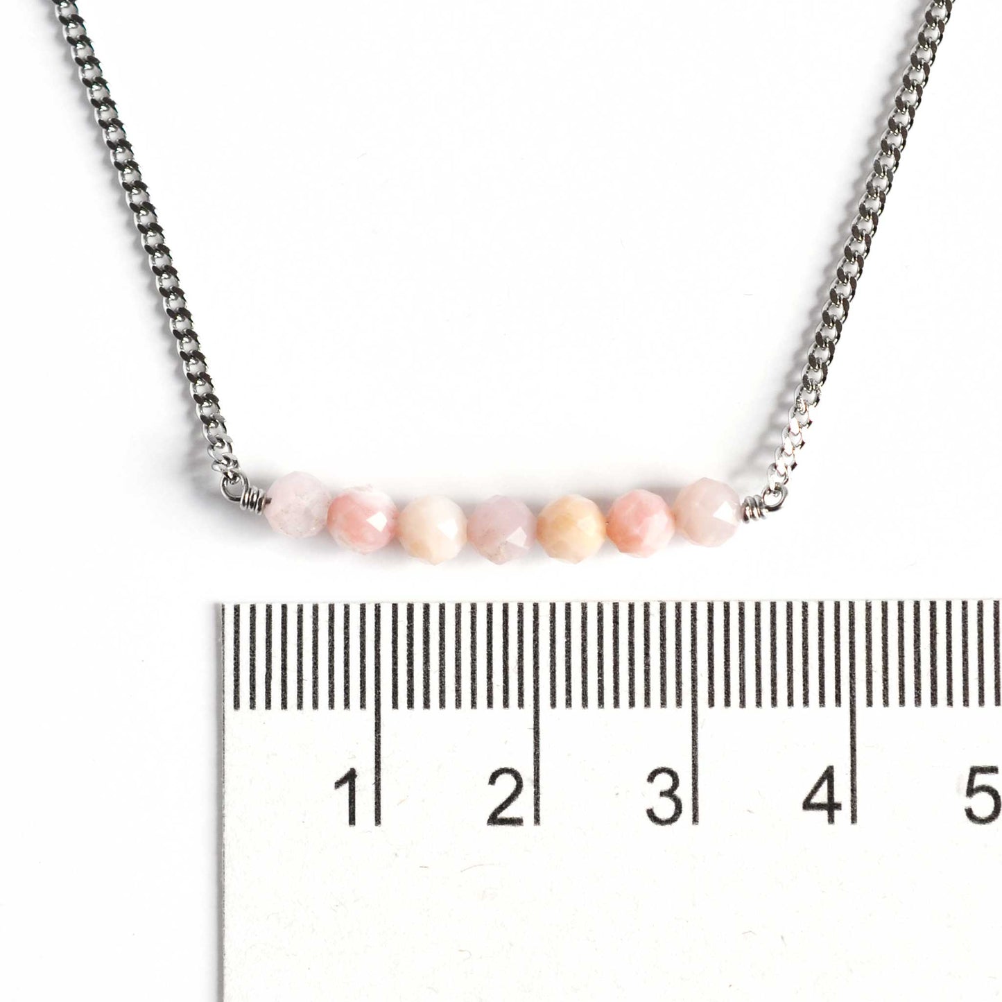 Dainty Pink Opal necklace with 4mm gemstone beads next to ruler