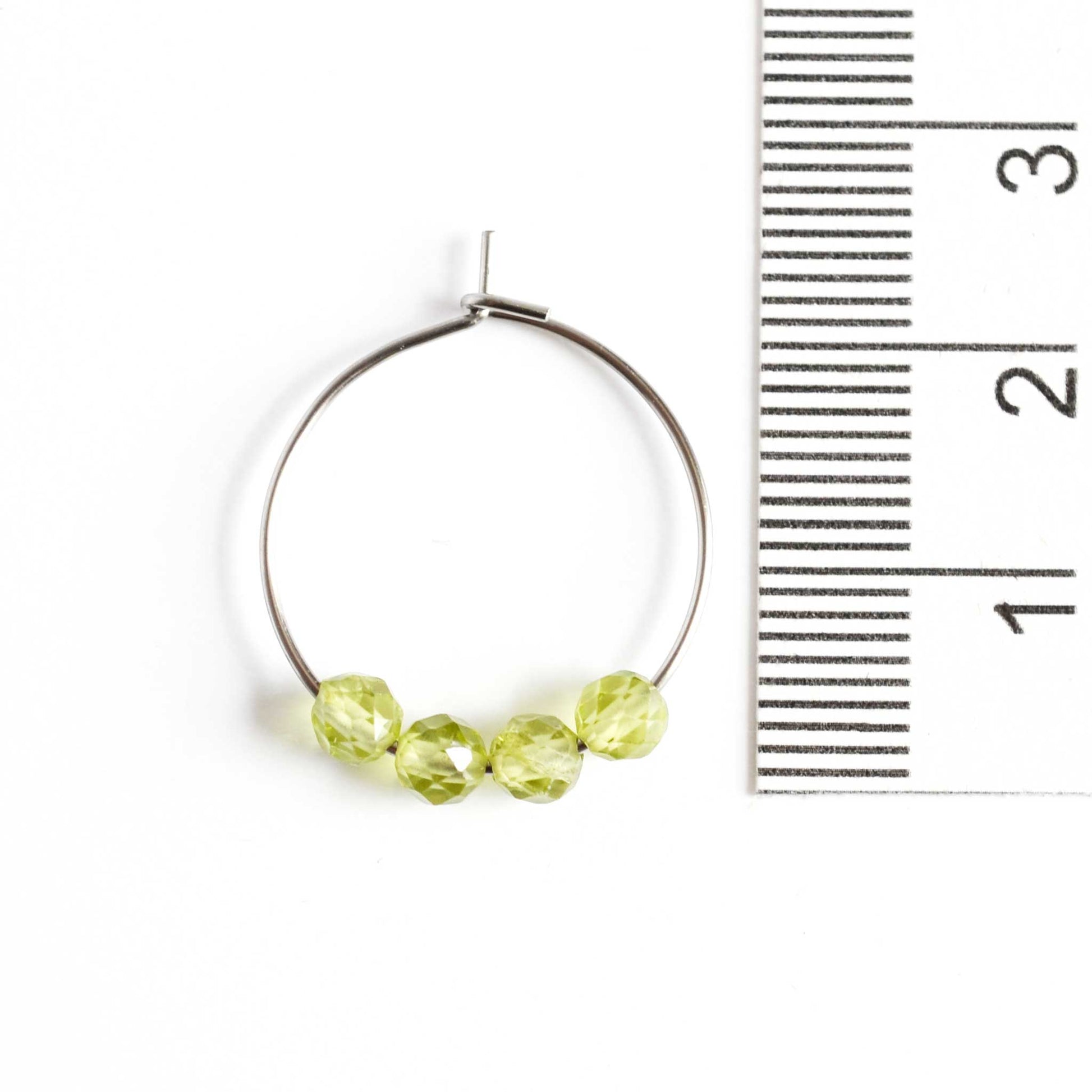 2cm diameter Peridot hoop earrings next to ruler