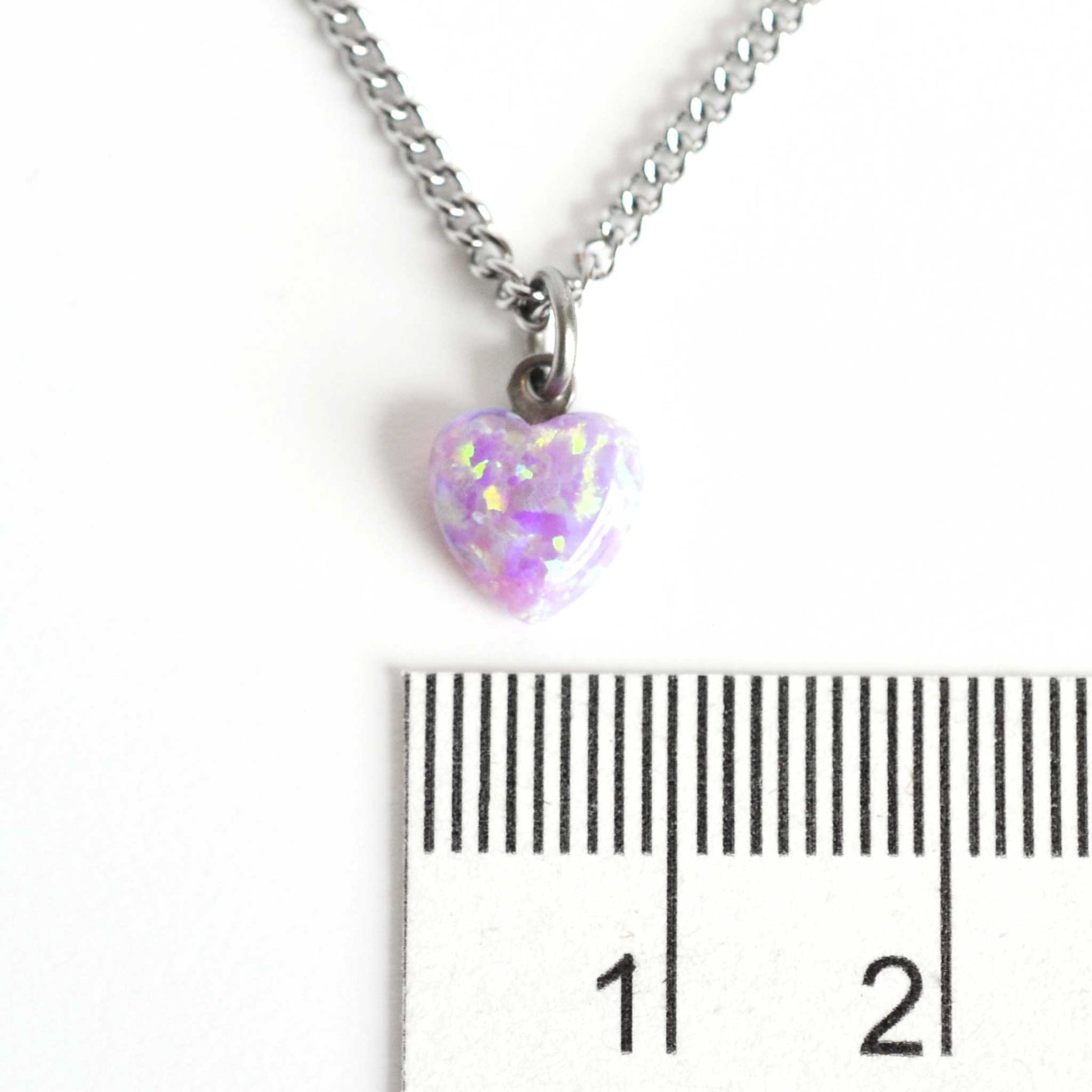 8mm pink heart necklace next to ruler