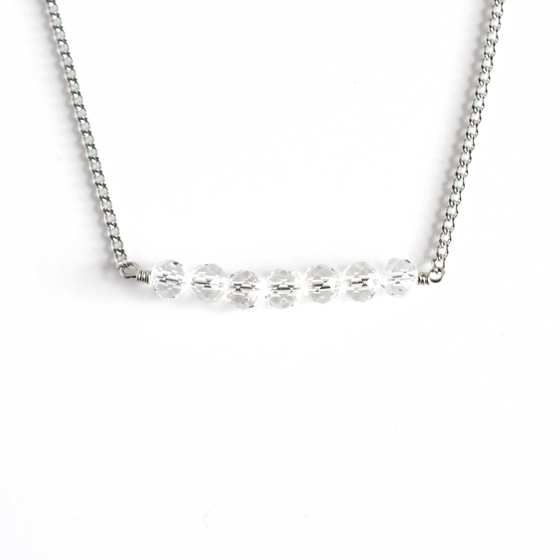 Clear crystal necklace with stainless steel chain on white background