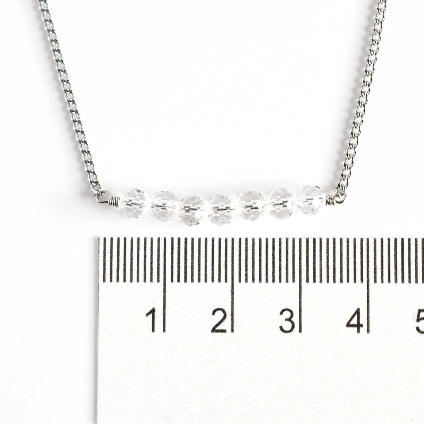 Dainty Rock Crystal necklace with 4mm gemstone beads next to ruler