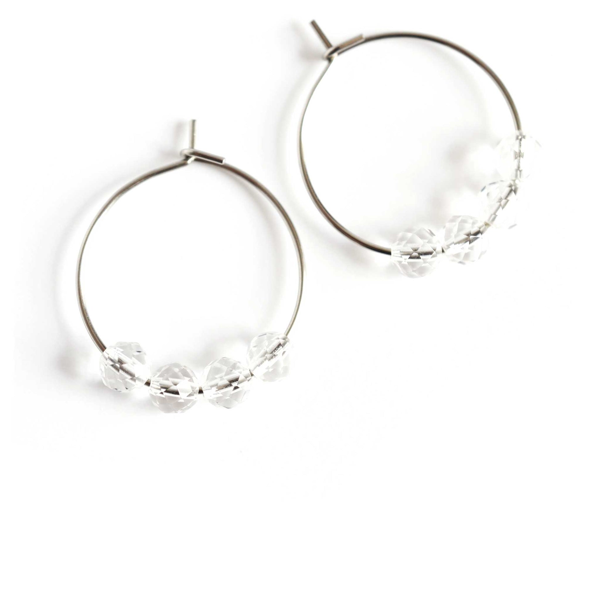 Clear Quartz Rock Crystal hoop earrings on white background