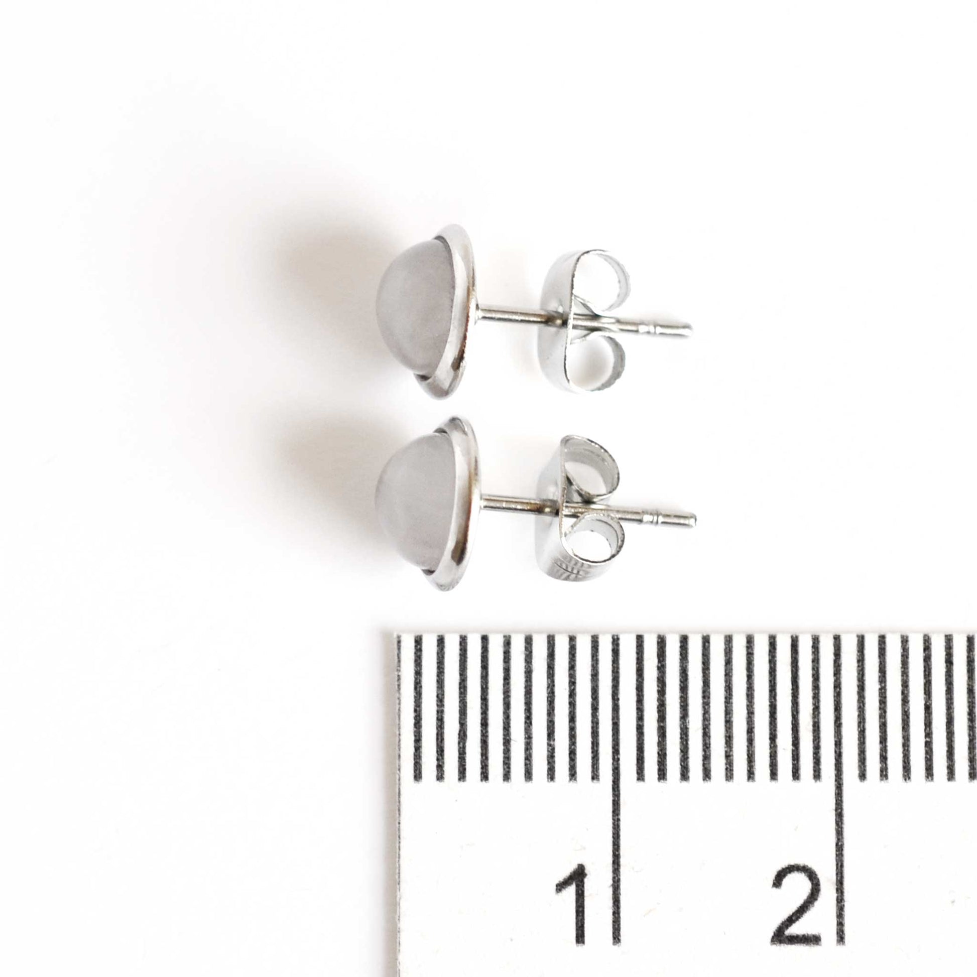 8mm diameter Rose Quartz stud earrings next to ruler