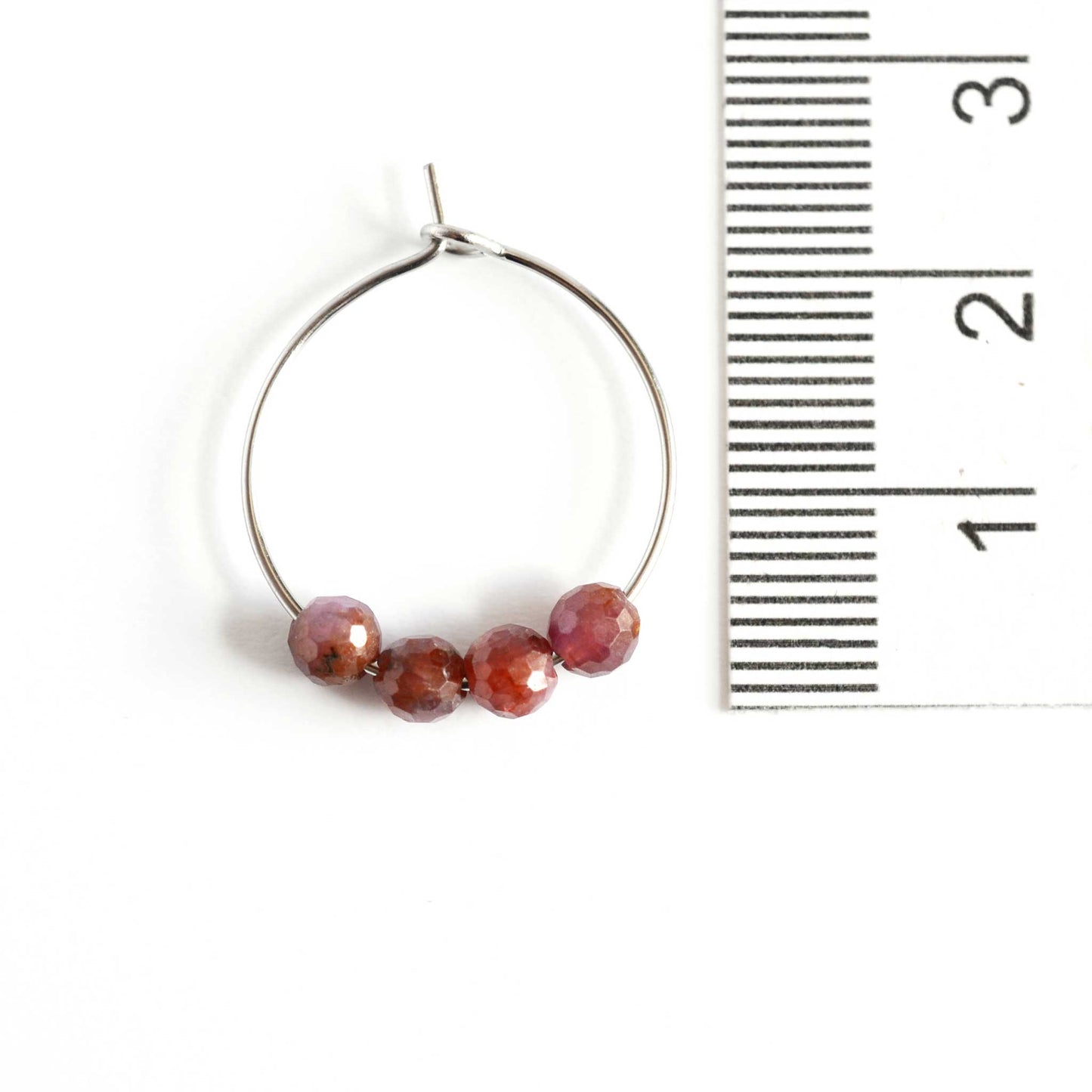 2cm diameter Ruby hoop earrings next to ruler