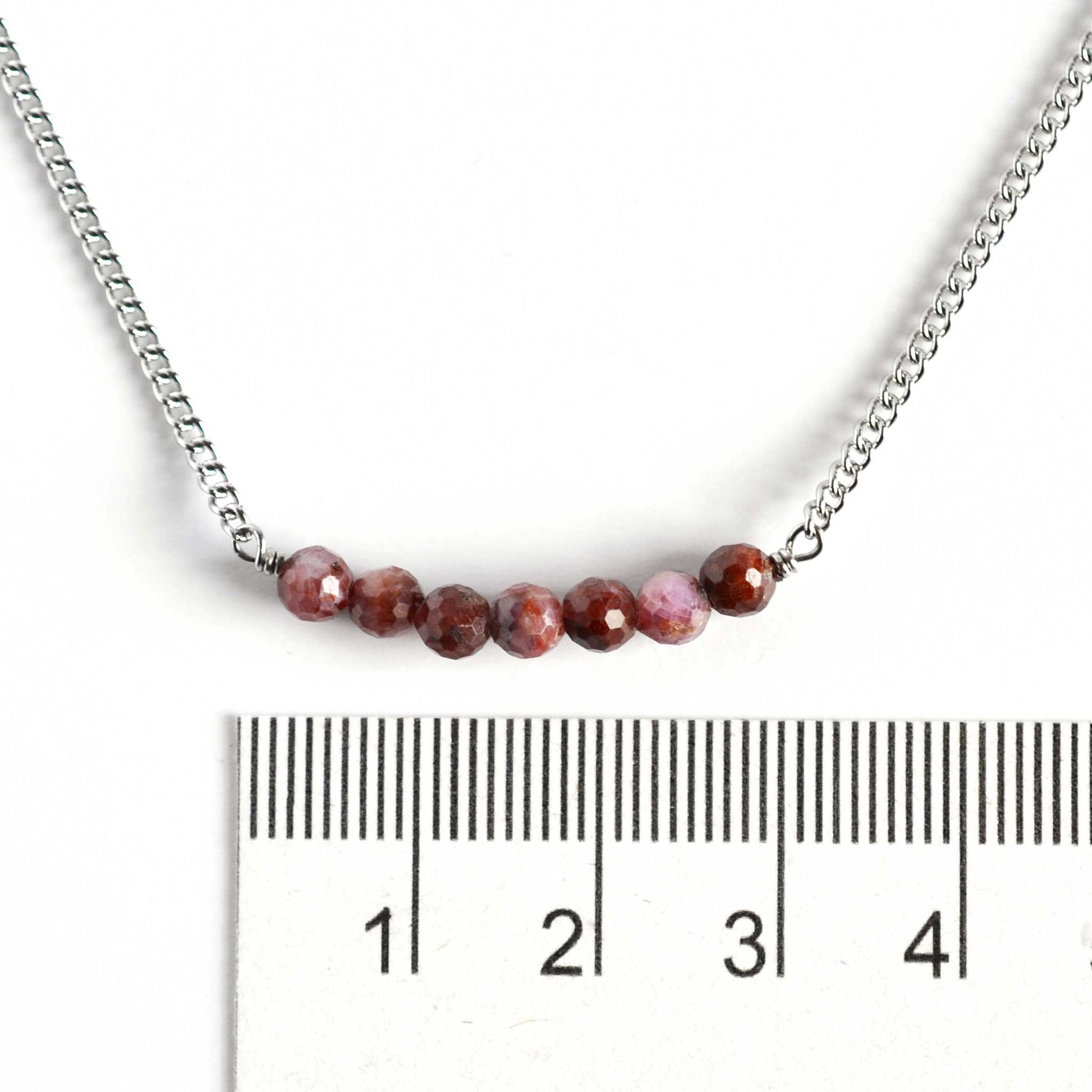 Dainty Ruby necklace with 4mm gemstone beads next to ruler