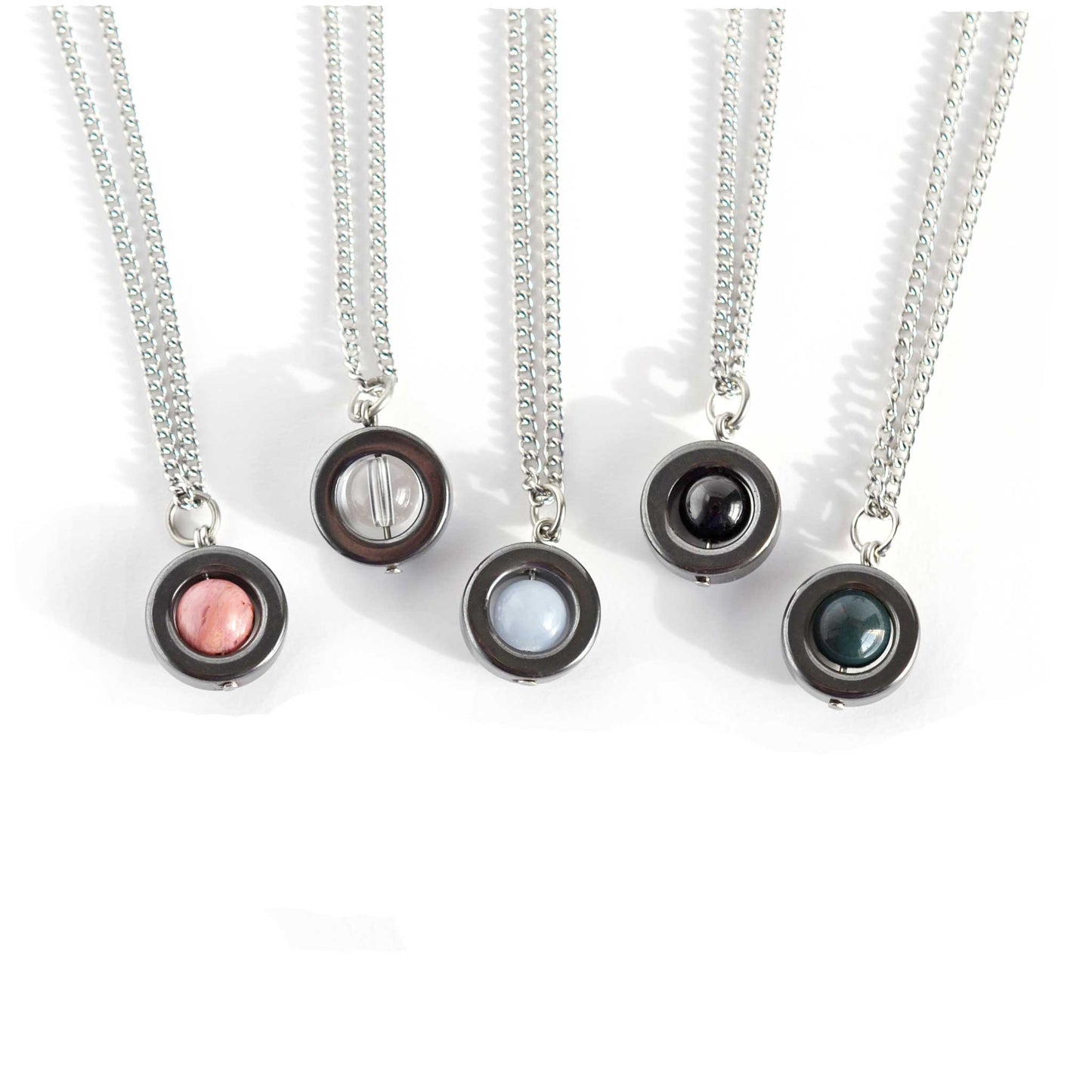 Rhodonite, Crystal, Angelite, Onyx & Bloodstone gemstone spinner necklaces on white background.