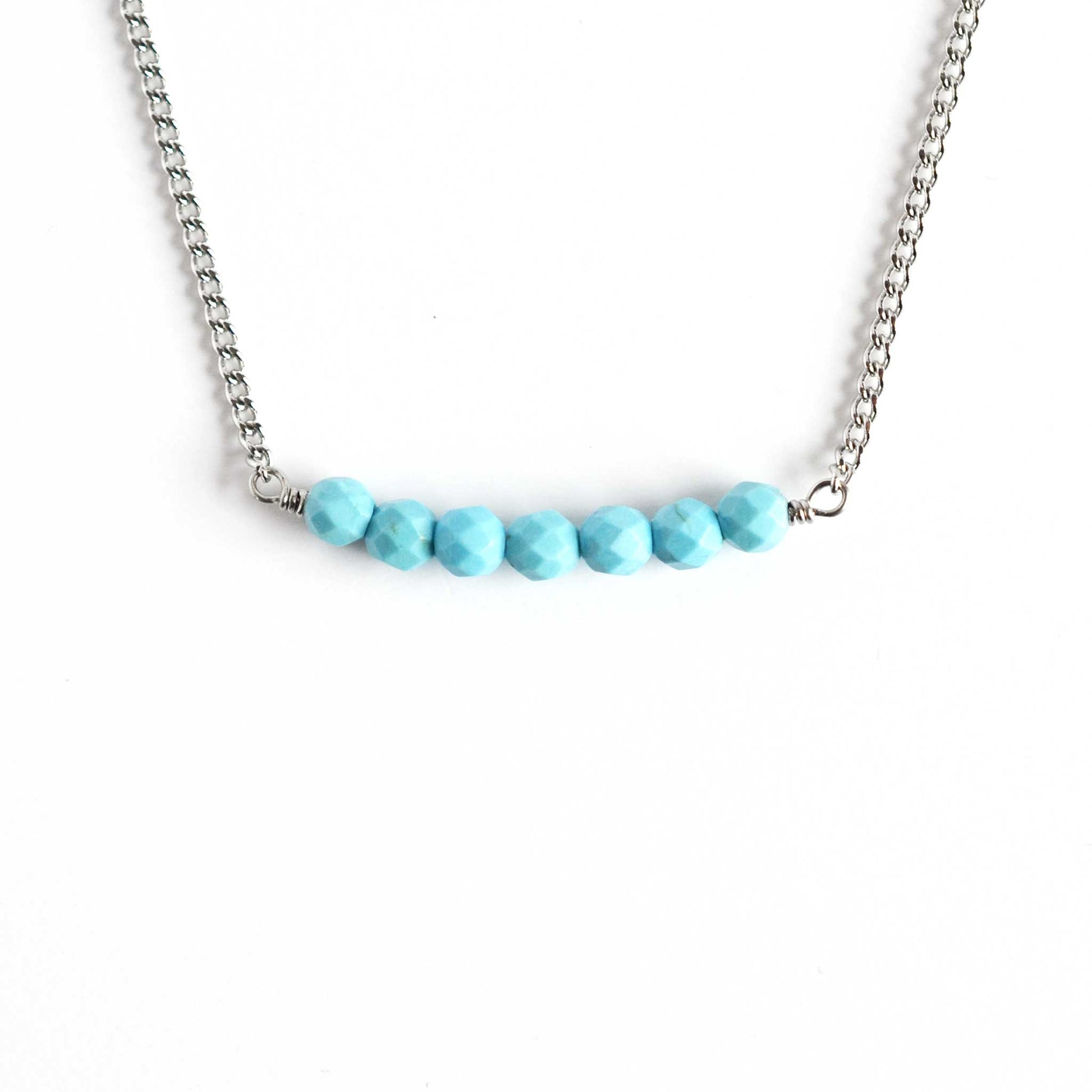 Turquoise bar necklace with stainless steel chain on white background
