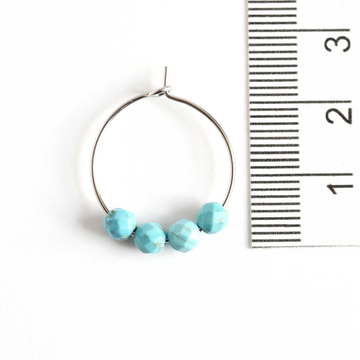 2cm diameter hoop earrings with Turquoise stones next to ruler