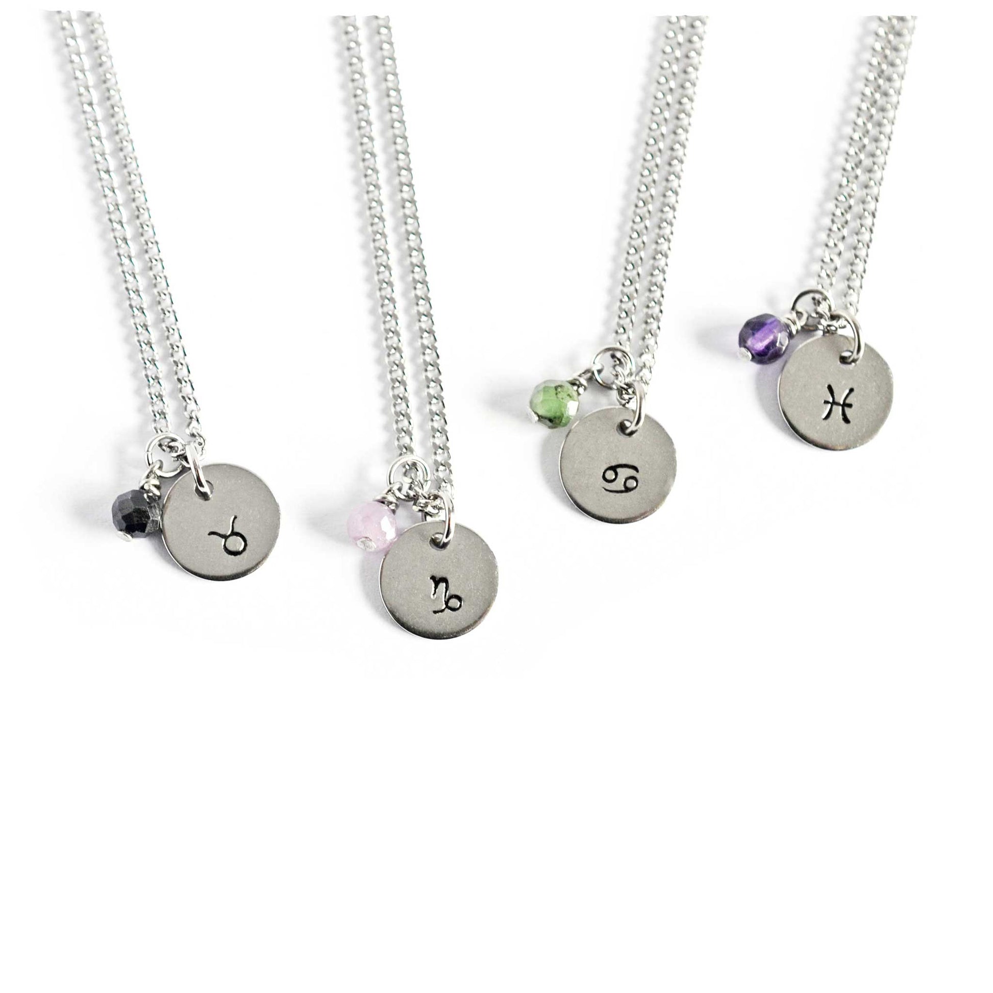 Necklace with zodiac sign and gemstone charm on white background